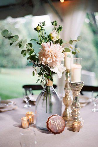 bohemian wedding decorations glass bottle with pink dahlias and greenery wooden tablenumber landonjacob