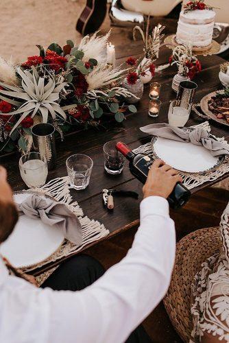 bohemian wedding decorations place setting with nacrame succulents and pampas grass red flowers alexandria monette photography