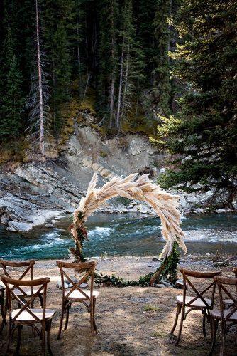 bohemian wedding decorations outdoor ceremony round arch with greenery and pampas grass paisley photography