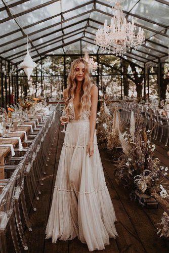 bohemian wedding decorations bride on reception in glass barn with pampas grass and bohemian dry flowers ayehkphotography