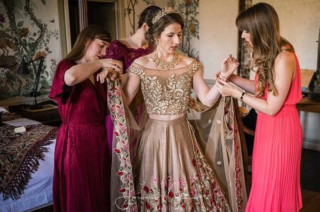 Bridesmaids assist Bride at St Giles House