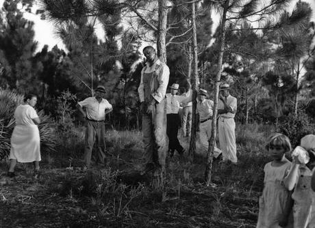 The body of Rubin Stacy, 32, hangs from a tree in Fort Lauderdale, Florida, as neighbors visit the site July 19, 1935. White lynchings of blacks were common during the era.