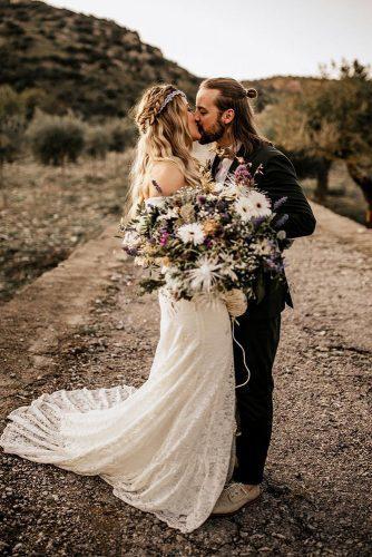 bohemian wedding look outdoor photoshoot groom with long hair bride in long dress with bright wildflower bouquet chrisandruth