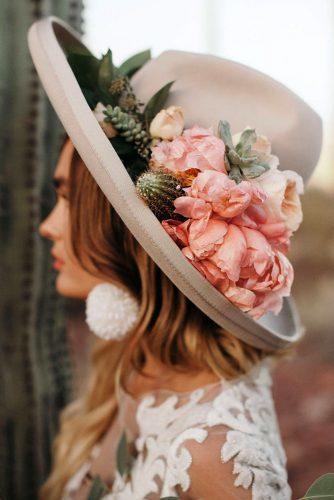 bohemian wedding look bride in grey boho hat decorated with pink flowers and desert cactuses jordan voth