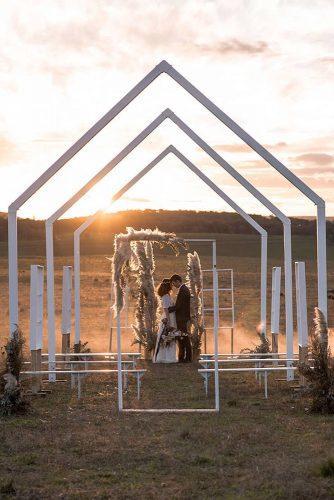 minimalist wedding decor desert ceremony with white frames michael boyle photography