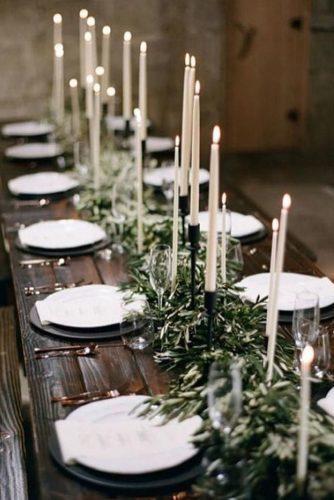minimalist wedding decor wooden long table with greenery and candles bryan n miller photography