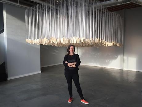 Ann Lewis with her installation, ...and counting, in Emerging Collective's new art space in Decatur, Atlanta.