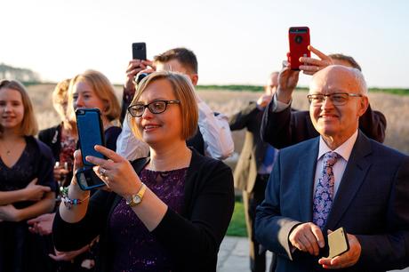 guests take photos of the couple