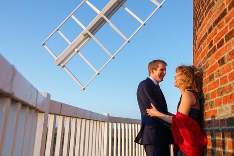 the bride and groom on the balcony of cley windmill