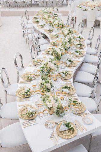 natural wedding décor white long wavy table with greenery centerpiece and gold karinapiresphotography