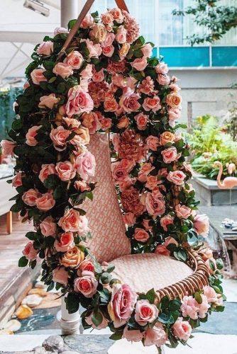 natural wedding décor hanging chair decorated with pink roses flordepassion