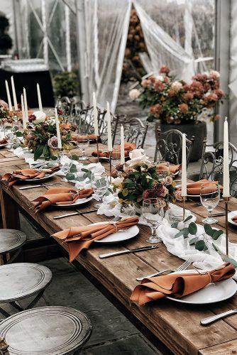 rust wedding color reception under transparent tent with white tablerunners candles and flowers alexmari_