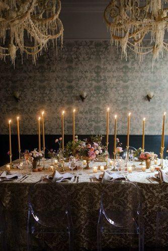 rust wedding color ethnic tablecloth candles and flowers on table hanging decorations yeahweddings