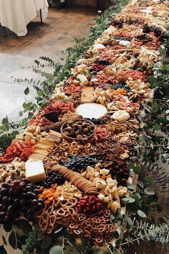 rust wedding color long catering table decorated with greenery savourandgraze