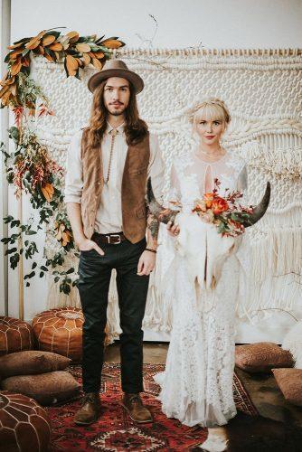 rust wedding color macrame backdrop with greenery and leaves bohemian groom and bride nhiya kaye photography