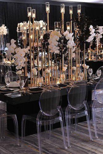 modern wedding decor ideas black and gold reception with tall candlesticks and cascading orchids signatureexposure