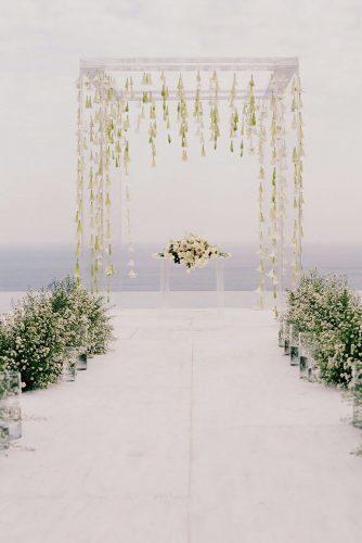 modern wedding decor ideas acrylic arch with hanging flowers and greenery aisle anggapermanaphoto