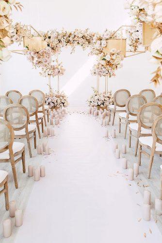 modern wedding decor ideas ceremony gold elements and pink roses and candles in aisle and altar purpletreephotography