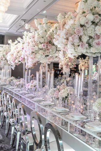 modern wedding decor ideas reception shiny acrylic table and chairs with tall pale pink flowers and candles centerpieces arianaphotographystudio