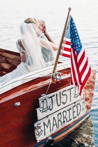 independence day wedding photography groom and bride in the boat decorated with american flag and sign justin & mary