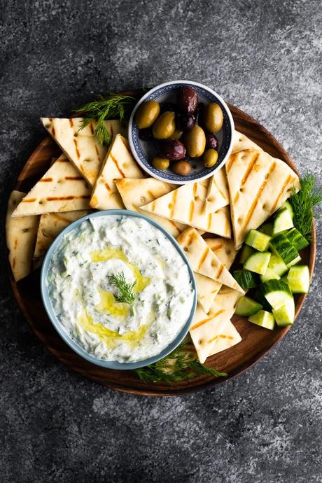 overhead view bowl of tzatziki sauce with grilled pita bread