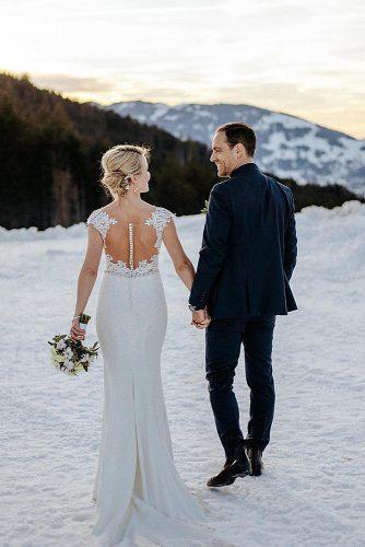 winter wedding couple together at the snow
