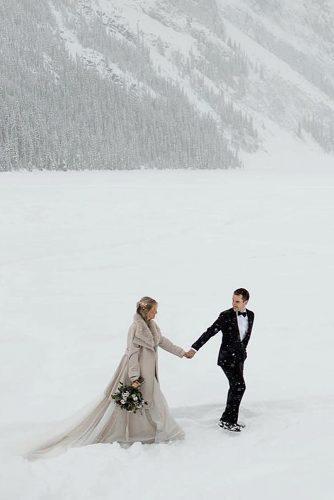 winter wedding bride and groom near mountains