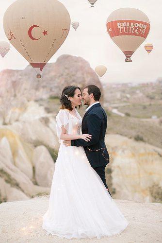intimate wedding newlyweds together in front of balloons cappadocia