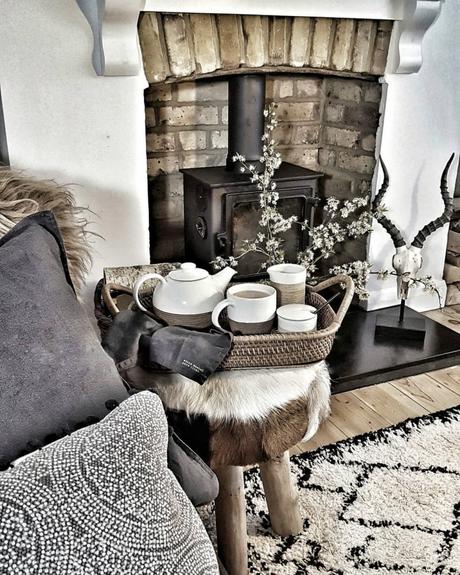 A rustic living room with a cast-iron fireplace.