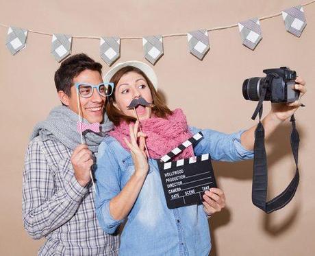 diy photo booth young couple with photo props