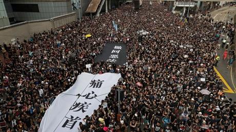 Huge crowds march in Hong Kong, piling pressure on leader