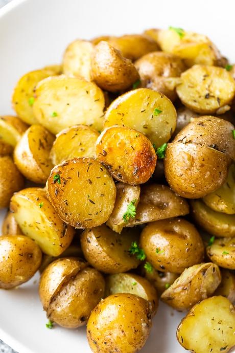 close up of crock pot potatoes on white plate
