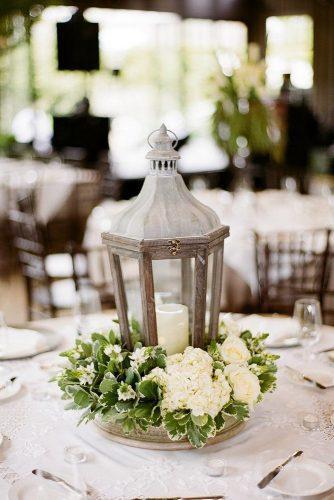 rustic wedding ideas lantern centerpiece with white flowers and greenery melissa schollaert photography