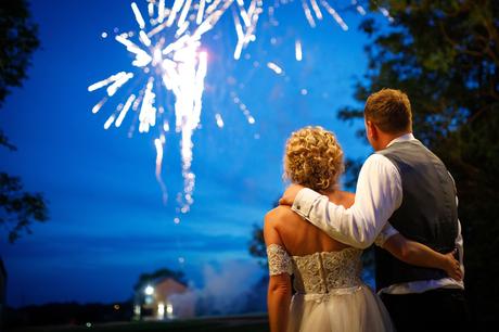 Summer Solstice Wedding – Polly and Steve bride and groom embrace in front of the fireworks