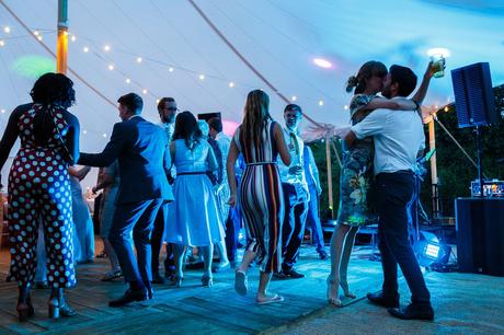 Summer Solstice Wedding – Polly and Steve a couple kiss on the dancefloor