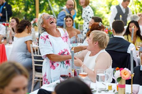 Summer Solstice Wedding – Polly and Steve tow wedding guests share a joke