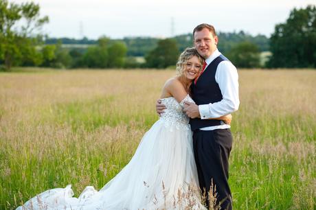 Summer Solstice Wedding – Polly and Steve bride and groom pose in a field