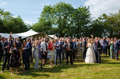Summer Solstice Wedding – Polly and Steve guests assemble to wave at a drone