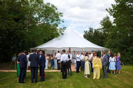 Summer Solstice Wedding – Polly and Steve guests outside the wedding marquee