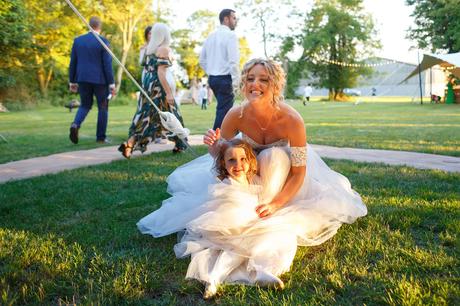 Summer Solstice Wedding – Polly and Steve the bride and child in the sunlight