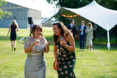 Summer Solstice Wedding – Polly and Steve the brides mother and a guest walk into the marquee
