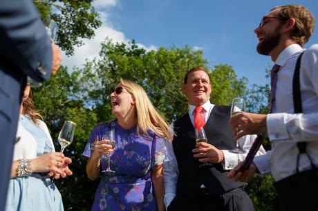 Summer Solstice Wedding – Polly and Steve the groom laughs with his family