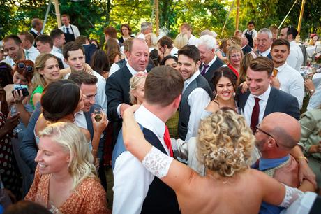 Summer Solstice Wedding – Polly and Steve wedding guests smiling at the bride and groom on the dancefloor