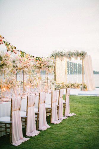 wedding ideas peachy pink and yellow outdoor bridal reception table and arch décor Saya Photography