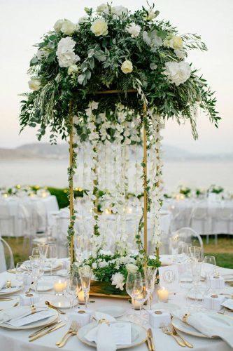wedding ideas tall centerpiece with greenery and hanging white flowers white_lilac_rentals