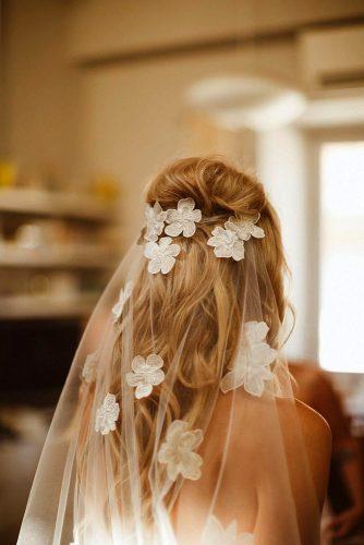wedding trends 2020 vintage volume blonde half up half down under the white veil with flowers wednova