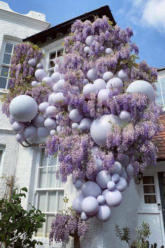 wedding ideas outdoor lilac balloon installation on the building elari_events