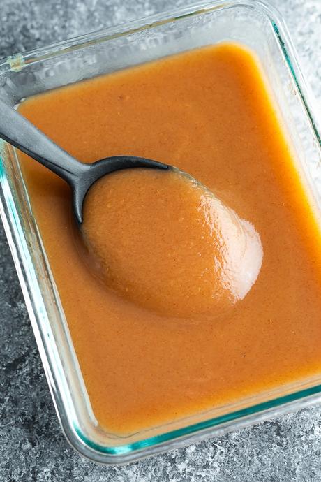 overhead view of meal prep container with instant pot applesauce on a spoon