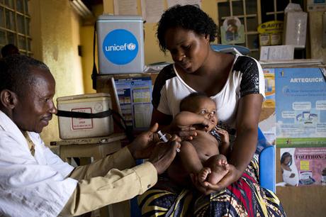 In November 2018, health worker Nsiri Lowoso vaccinates 3 months-old baby girl with the MMR (measles, mumps, rubella) vaccine, and the polio vaccine at Coopérative Solidarité Santé le Rocher, Lubumbashi, Democratic Republic of Congo (DRC)