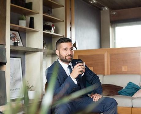 how to be a gentleman man sitting with glass